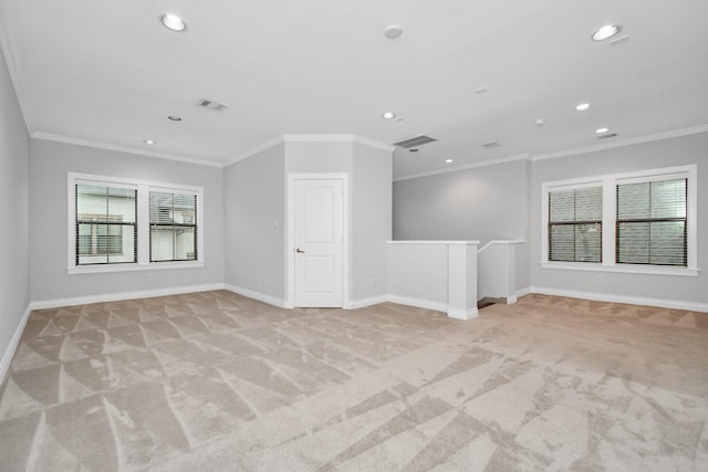 carpeted spare room featuring crown molding