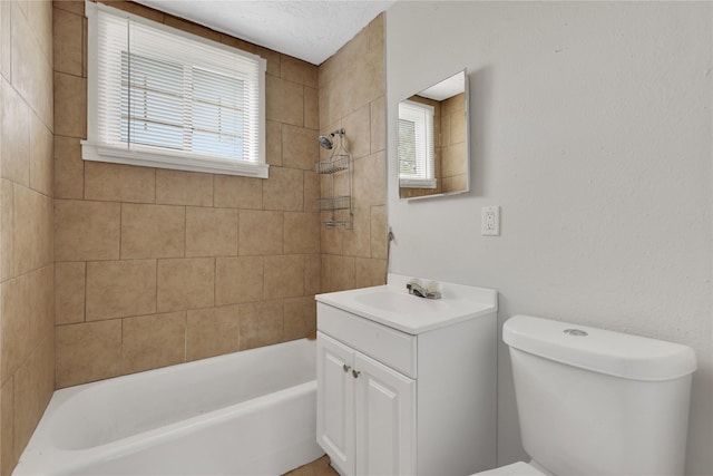 full bathroom with a healthy amount of sunlight, vanity, tiled shower / bath combo, and toilet