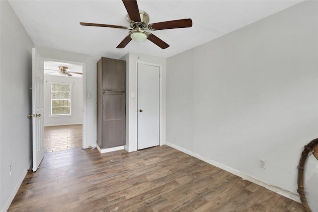 unfurnished bedroom featuring ceiling fan and wood-type flooring