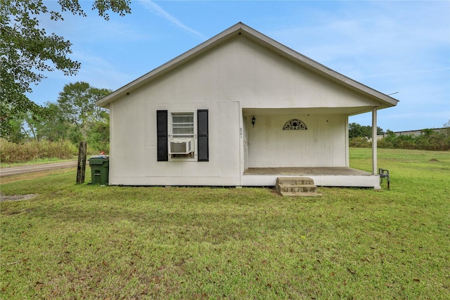 back of house featuring a yard and cooling unit