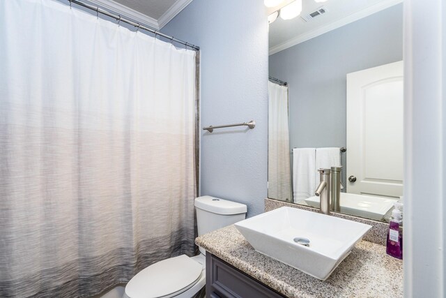 bathroom featuring crown molding, vanity, and toilet