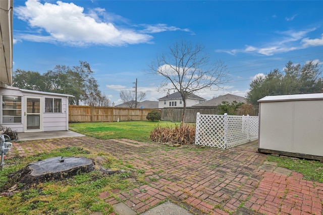 view of yard with a storage shed and a patio area