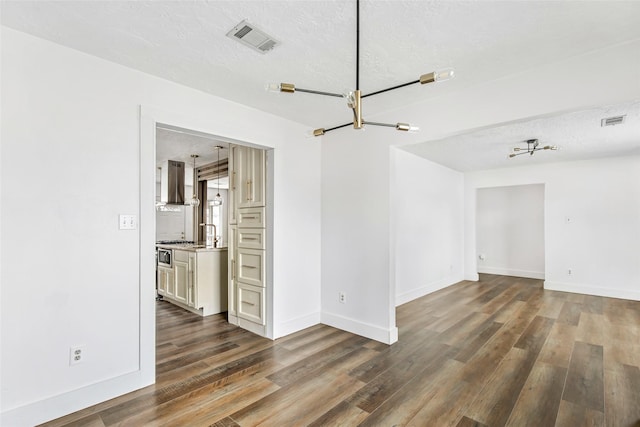 unfurnished room with dark hardwood / wood-style floors and a textured ceiling