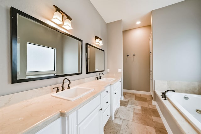 bathroom with vanity and a washtub