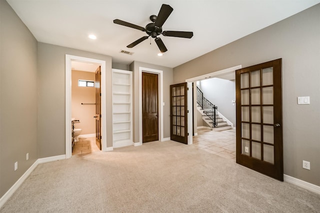 empty room with light carpet, ceiling fan, and french doors