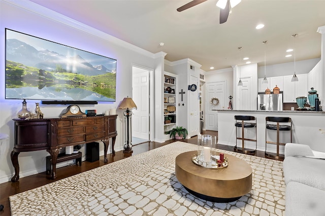 living room featuring ornamental molding, hardwood / wood-style floors, and ceiling fan