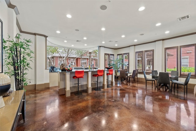 kitchen with ornamental molding and a kitchen breakfast bar