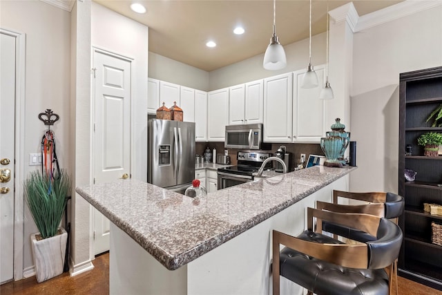 kitchen featuring decorative light fixtures, white cabinetry, light stone counters, kitchen peninsula, and stainless steel appliances