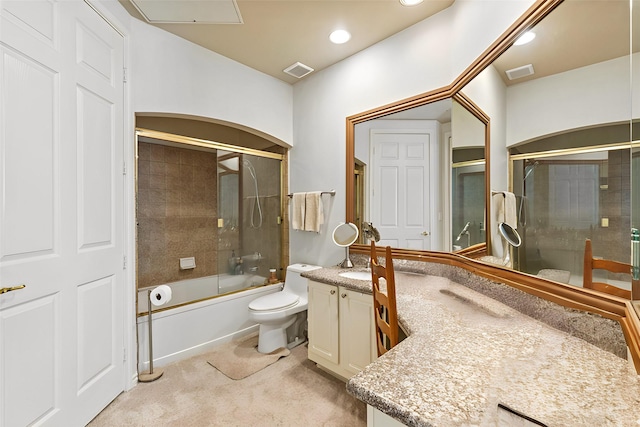 full bathroom featuring vanity, enclosed tub / shower combo, and toilet