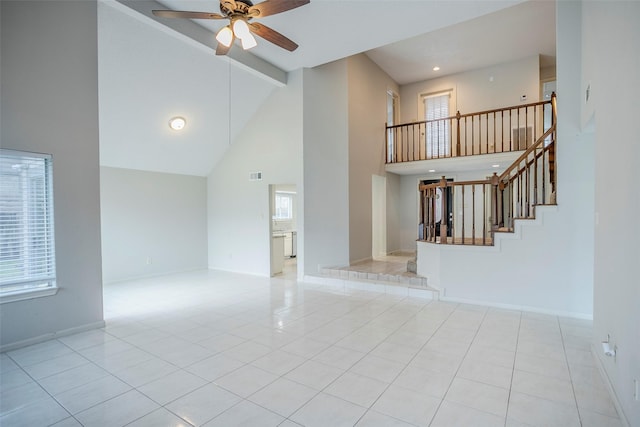 unfurnished living room featuring ceiling fan, high vaulted ceiling, light tile patterned floors, and beam ceiling