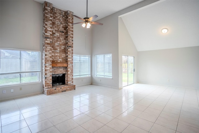 unfurnished living room with light tile patterned flooring, ceiling fan, high vaulted ceiling, and a brick fireplace