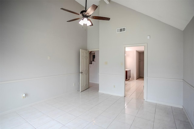 empty room with ceiling fan, lofted ceiling, and light tile patterned floors