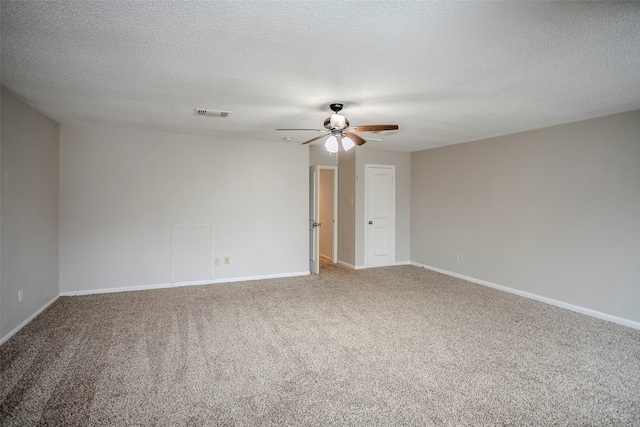 carpeted spare room with a textured ceiling and ceiling fan