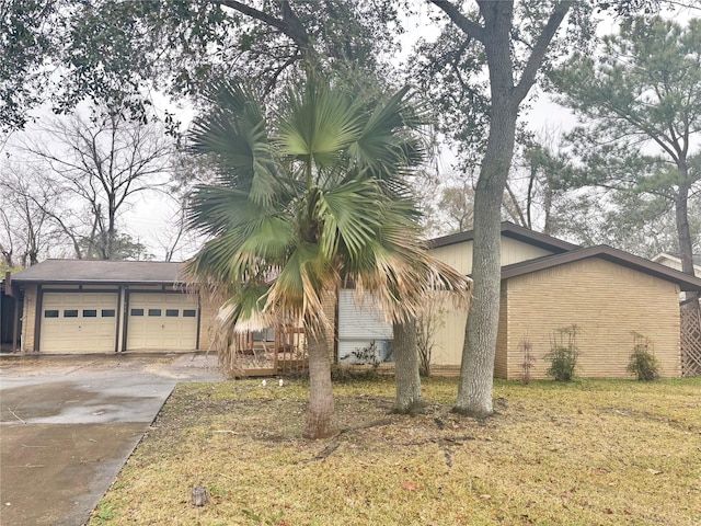 view of front of property with a garage and a front lawn