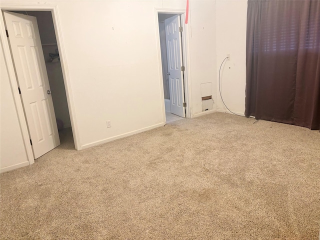 unfurnished bedroom with light colored carpet