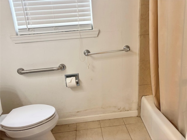 bathroom featuring tile patterned flooring, shower / tub combo, and toilet