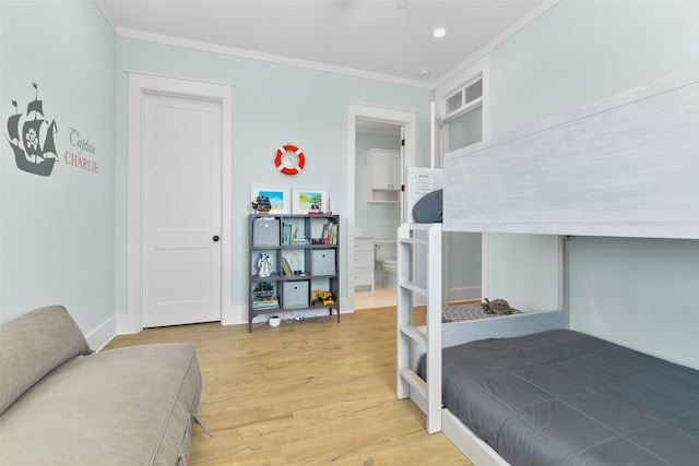 bedroom with light hardwood / wood-style flooring and ornamental molding