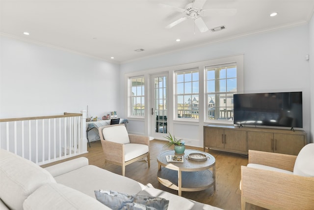 living room featuring ornamental molding, ceiling fan, and light hardwood / wood-style floors