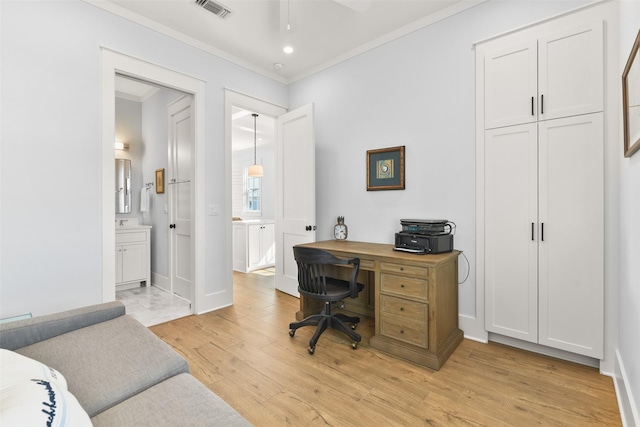 home office with crown molding, ceiling fan, and light wood-type flooring