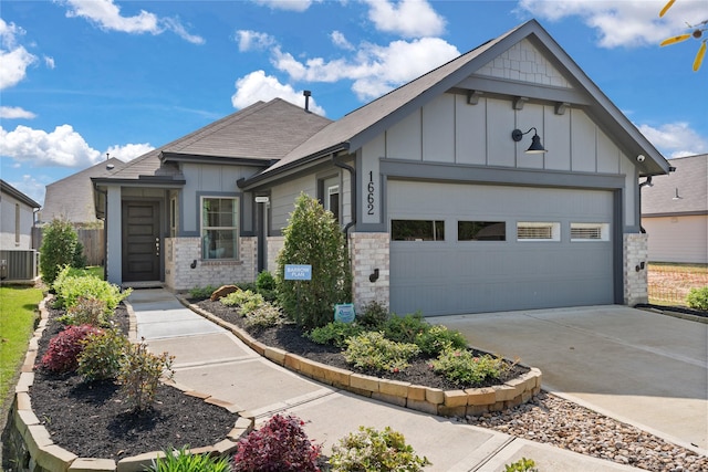 view of front of home featuring cooling unit and a garage