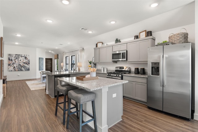 kitchen featuring appliances with stainless steel finishes, gray cabinetry, and kitchen peninsula