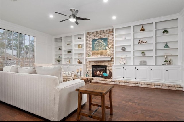 living room featuring a brick fireplace, dark hardwood / wood-style floors, and ceiling fan