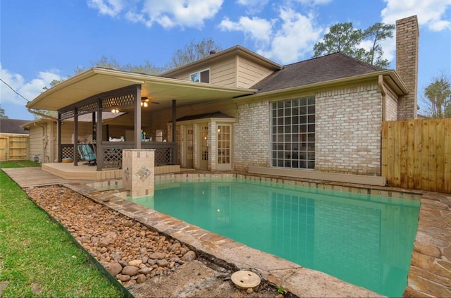 view of swimming pool with a patio and ceiling fan