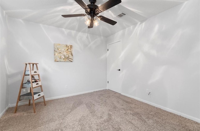 carpeted spare room with ceiling fan