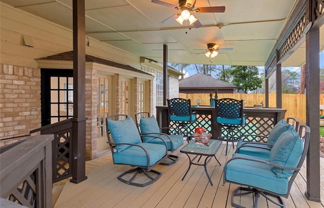 wooden deck with ceiling fan and an outdoor bar