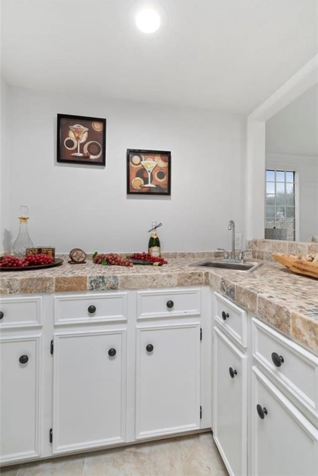 kitchen with white cabinetry and sink