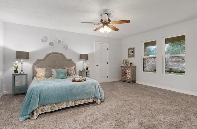 carpeted bedroom with a textured ceiling and ceiling fan