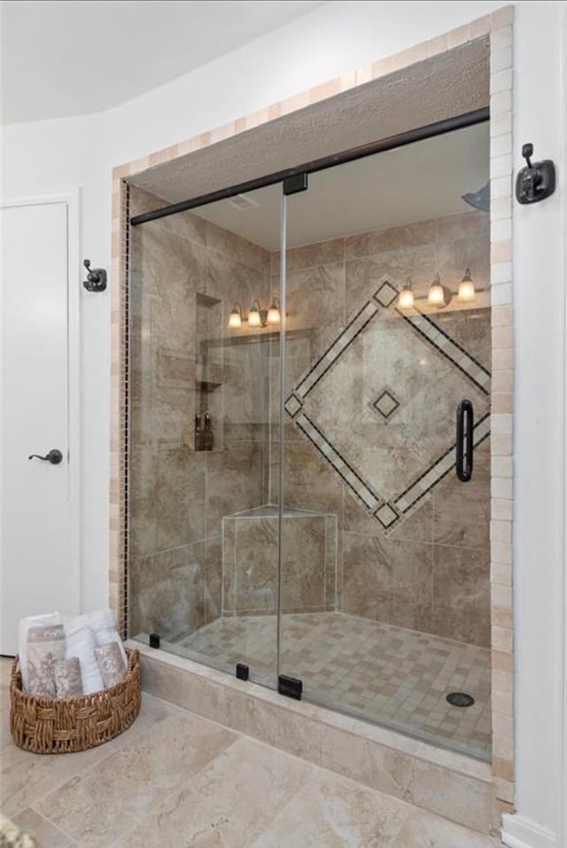 bathroom with a shower with shower door