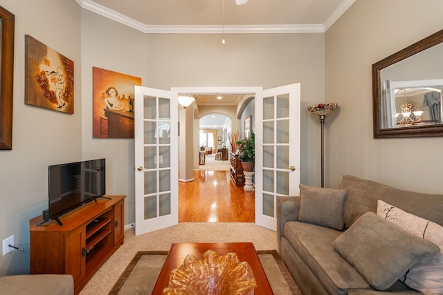 living room with light carpet, ornamental molding, and french doors