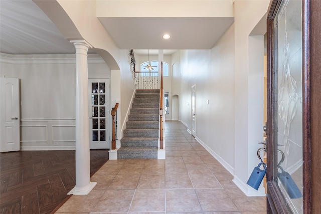 entryway with ceiling fan, decorative columns, and light parquet floors