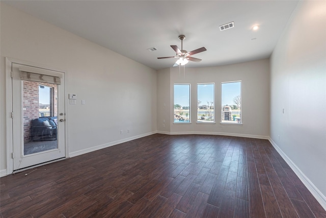 spare room featuring ceiling fan and dark hardwood / wood-style flooring