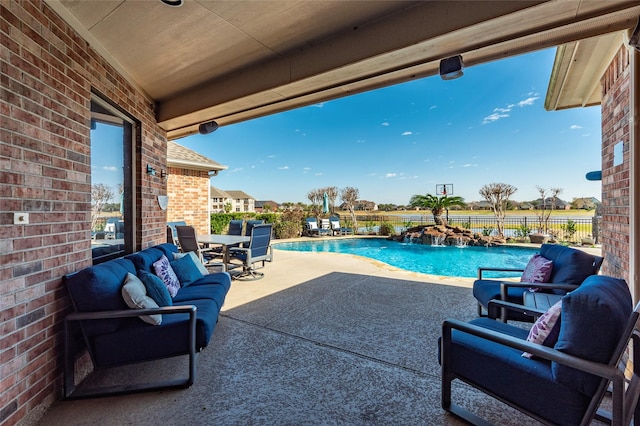 view of swimming pool with a patio area, outdoor lounge area, and pool water feature