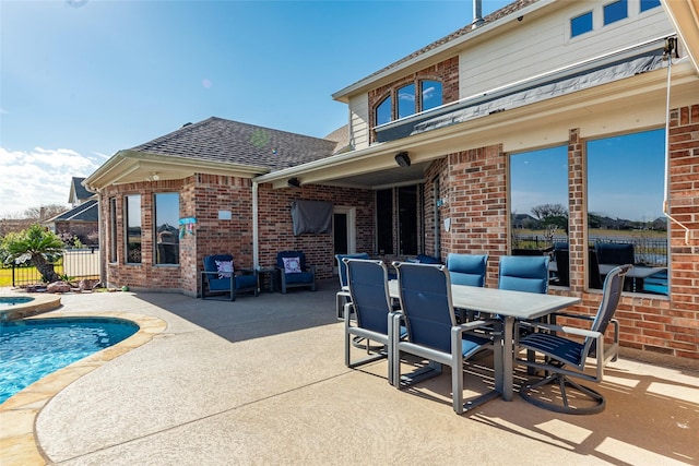 exterior space featuring a swimming pool with hot tub and a patio