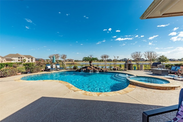 view of pool with an in ground hot tub and a patio