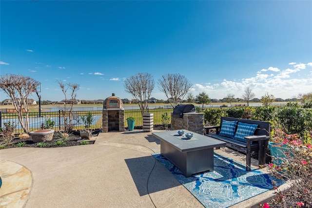 view of patio / terrace with a water view and an outdoor living space