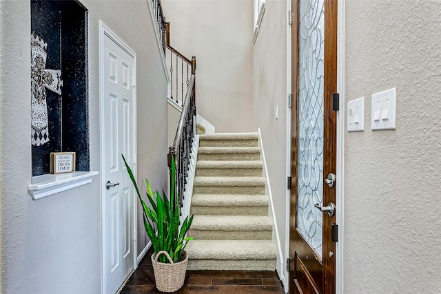 staircase with hardwood / wood-style flooring