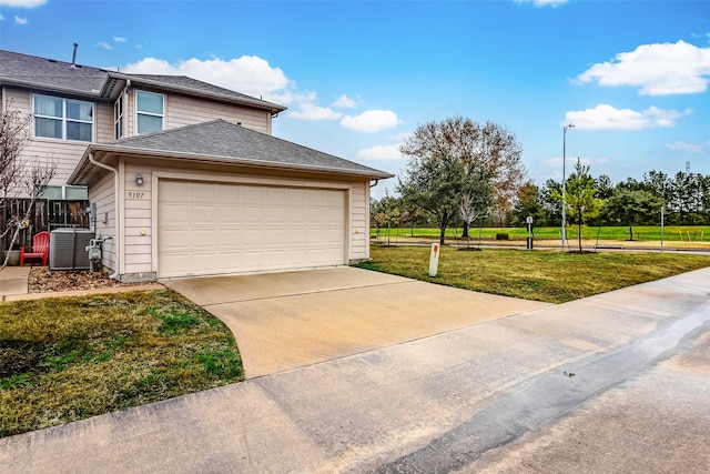 view of property exterior featuring central AC, a garage, and a lawn