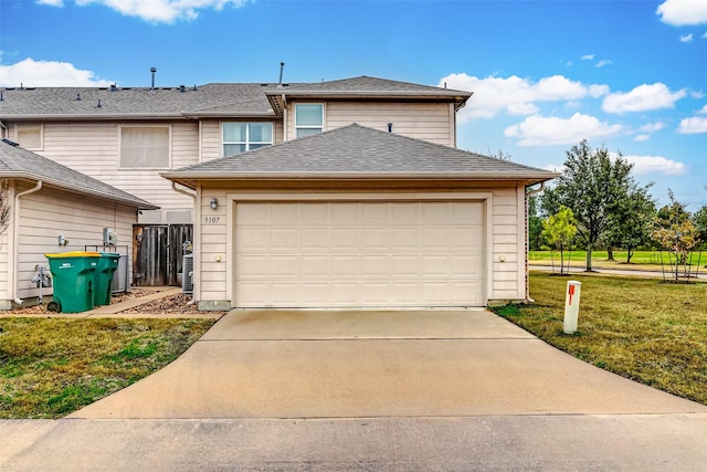 view of front of property with a garage and a front lawn