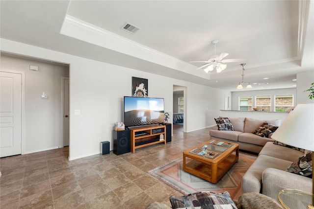 living room featuring a tray ceiling and ceiling fan