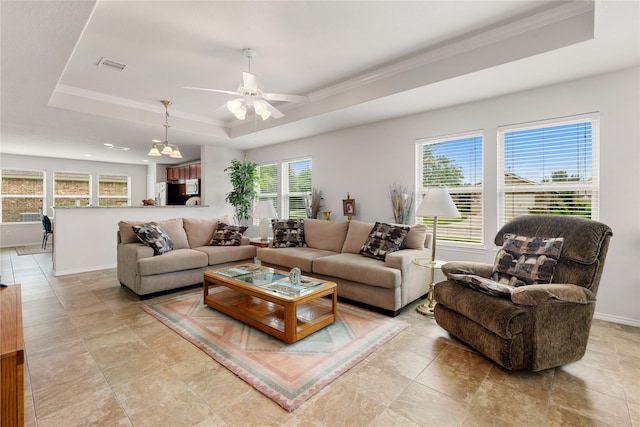 living room with ornamental molding, a raised ceiling, and ceiling fan