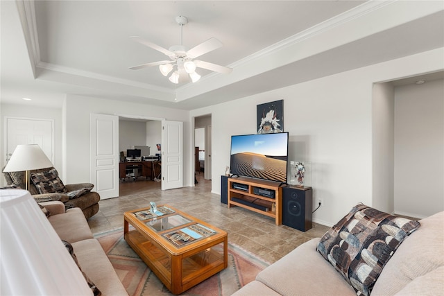 living room featuring crown molding, a raised ceiling, and ceiling fan