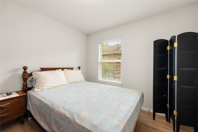 bedroom with hardwood / wood-style floors