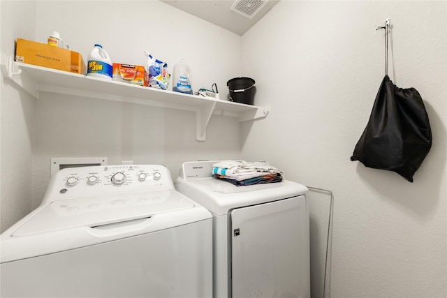 laundry room with washing machine and clothes dryer