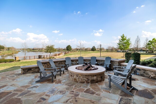 view of patio / terrace with a water view and an outdoor fire pit