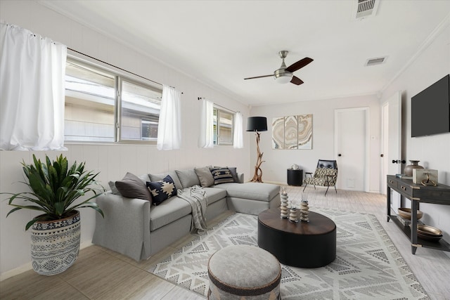 living room featuring crown molding and ceiling fan