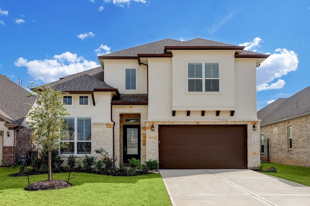 view of front facade featuring a garage and a front yard